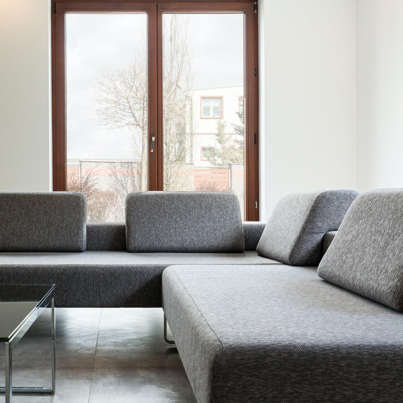 Light interior with big windows and sofa